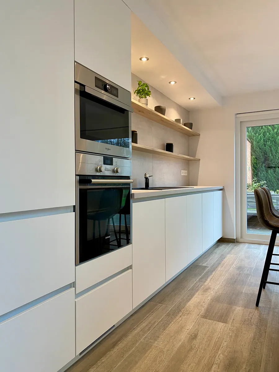 Witte keuken met houten elementen en betonlook werkblad